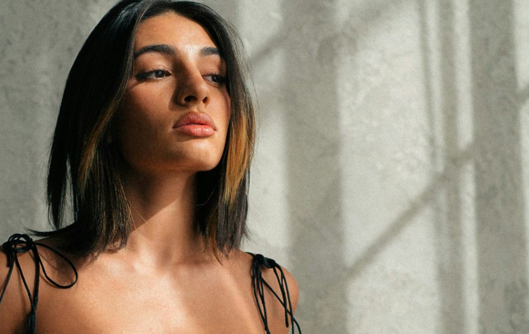 Woman with long hair in soft lighting.