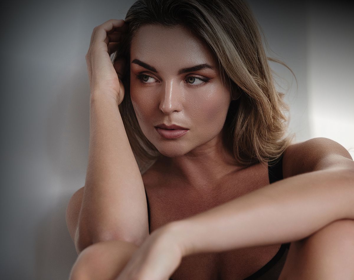 Close-up of a contemplative woman looking away.